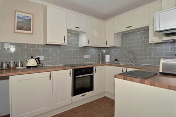 Kitchen is equipped with plenty of utensils, cutlery and crockery